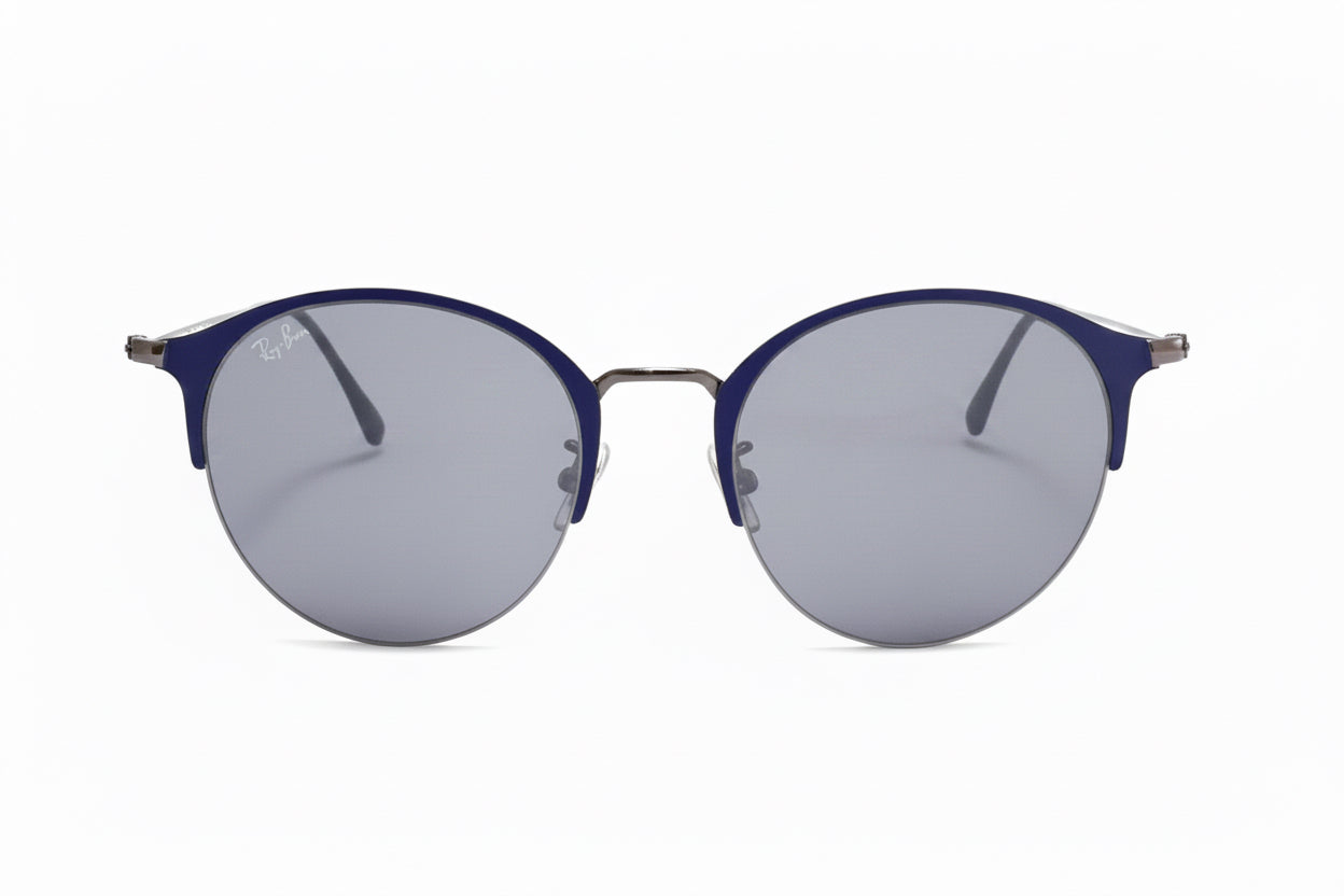 Ray-Ban round sunglasses with a dark blue acetate frame and silver-tone metal rims, featuring gray mirrored lenses.